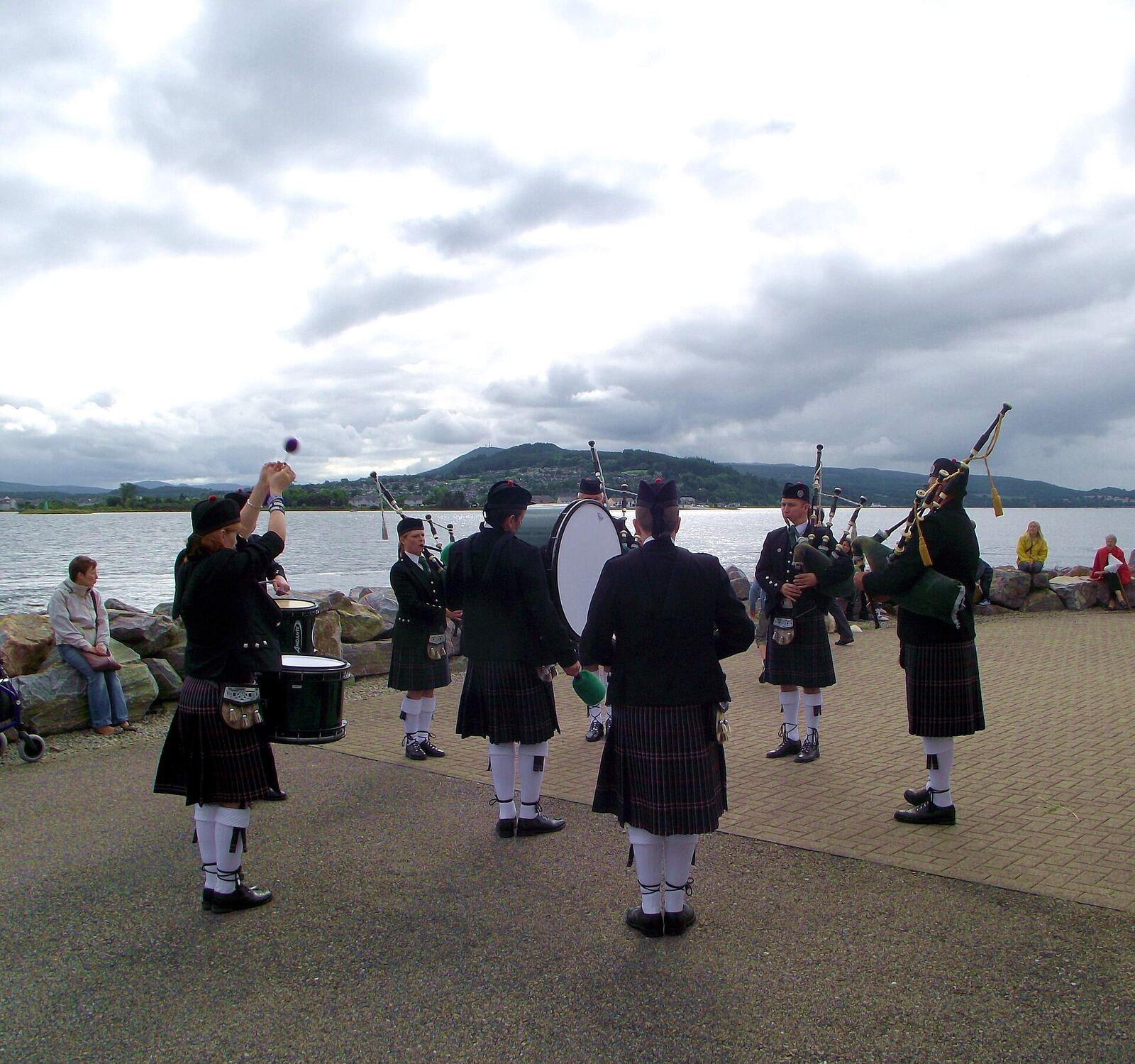 Scottish Pipe Band | Love Hurtz A Scottish pipe band performs outdoors, offering a visual representation of emotional expression and trauma recovery.