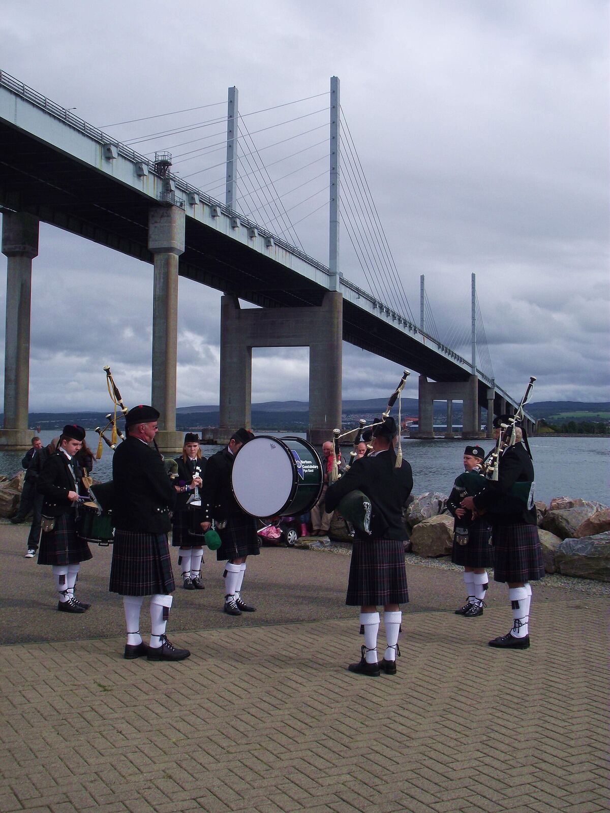 Scottish Pipe Band | Love Hurtz A Scottish pipe band performs near the Forth Bridge, representing resilience and finding strength through grief.